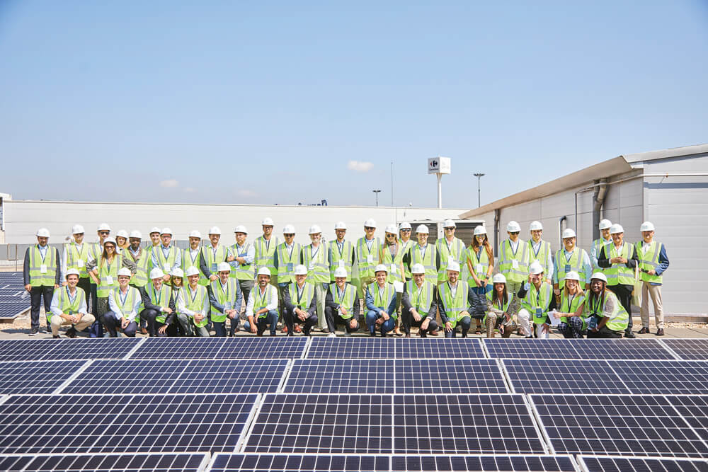 group of edp employers standing next to solar panels