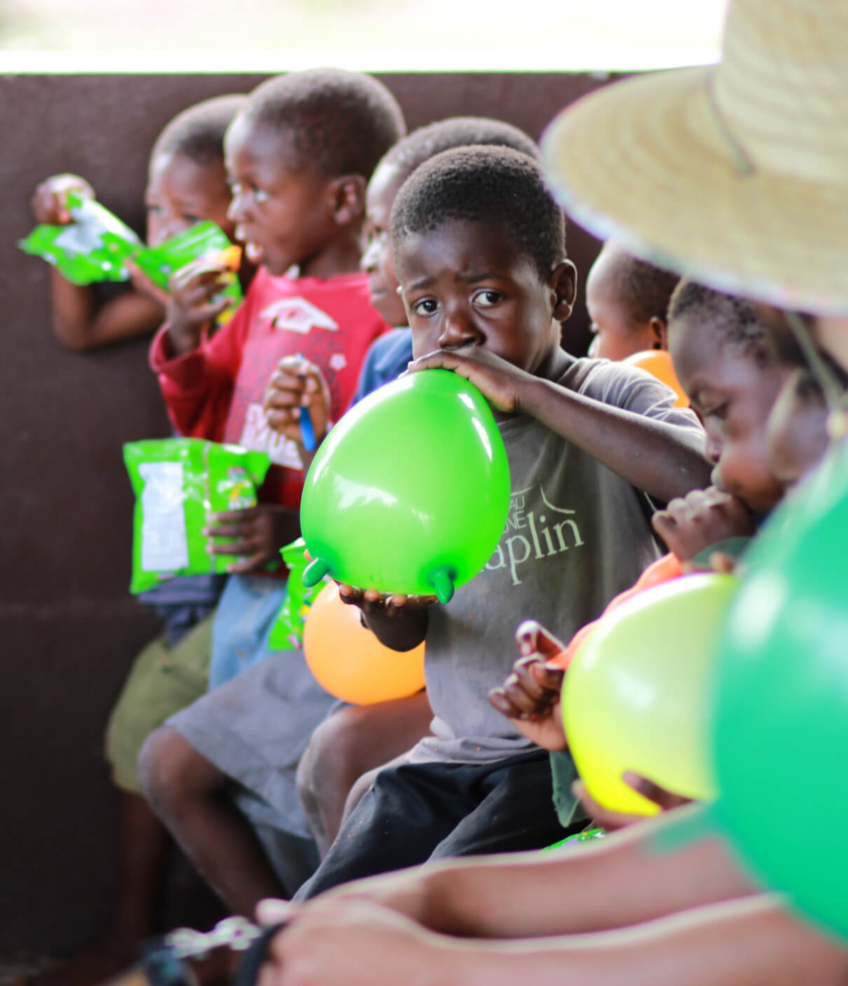 kids blowing green baloons