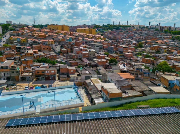 solar panels row installed next to a favela