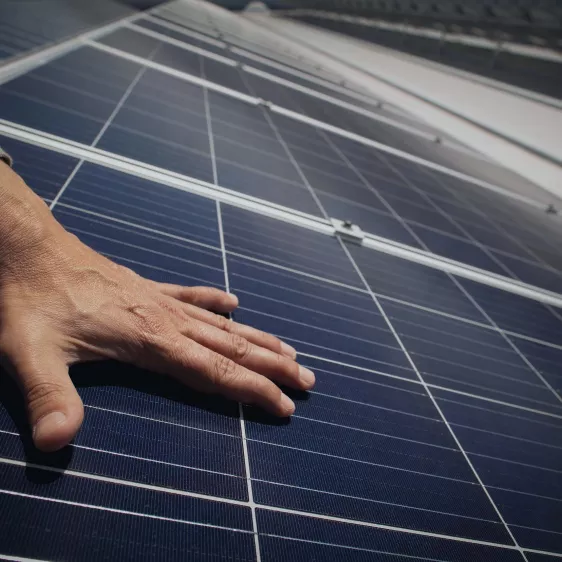 hand on a solar panel