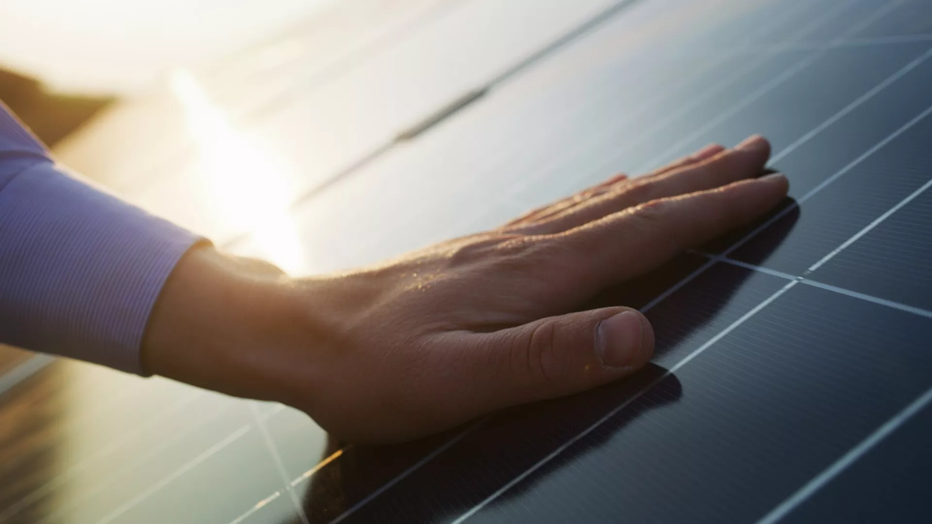 hand and solar panel