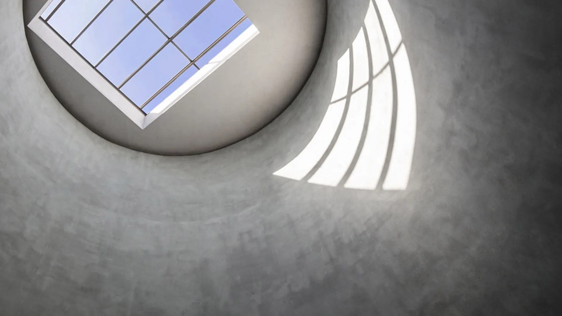 View from above of a window and its reflection on a round wall