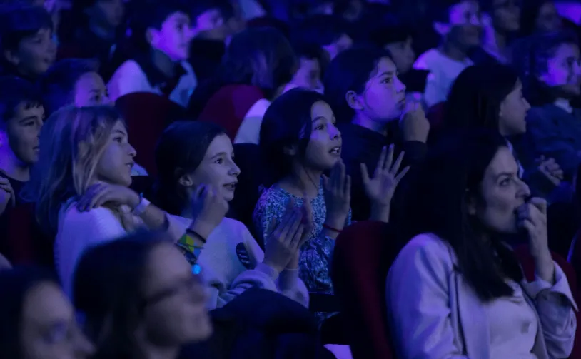 Kids sitting on an auditorium in a gala