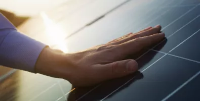 hand and solar panel