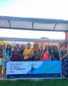 Professores posam com a placa da Escola da Energia